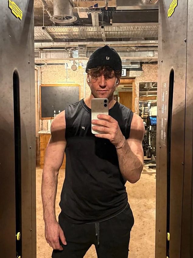 Ross taking a mirror photograph in exercise clothes