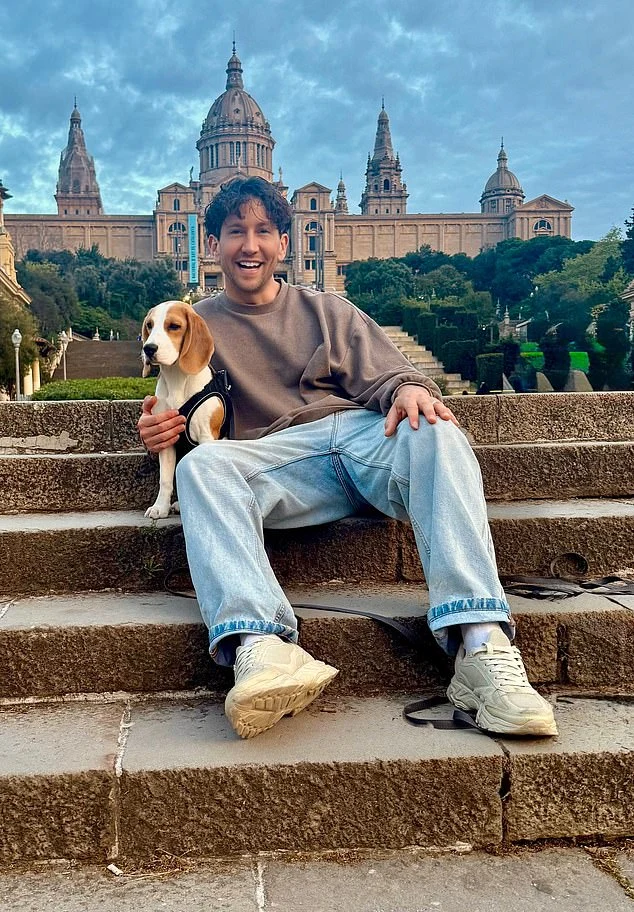 Ross sitting outdoors on stone steps with a dog beside him