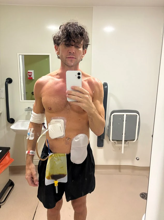 Ross standing in a hospital bathroom with medical dressings and drainage bags after his procedures